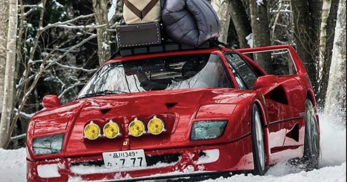 A Ferrari loaded with luggage, stuck in the snow