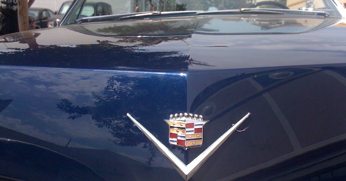 The hood of a blue Cadillac