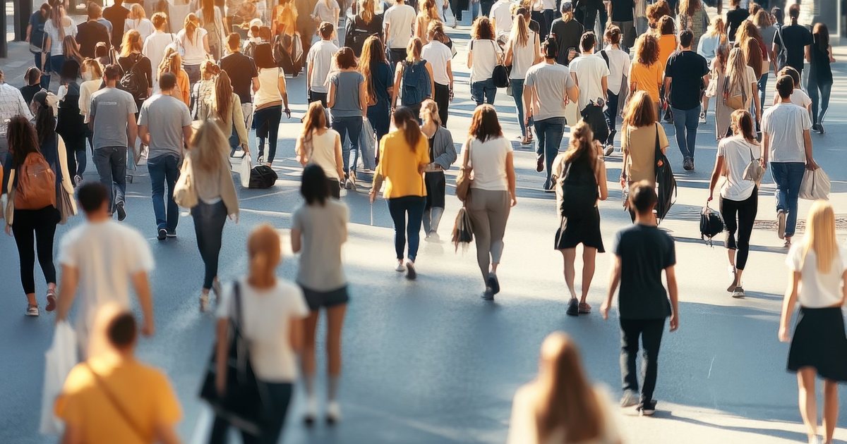 A crowd crossing a city street