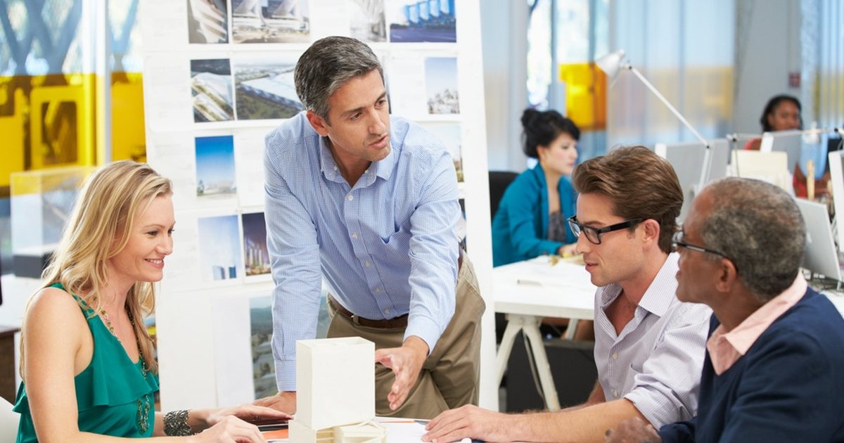 A manager talking through a model with his team