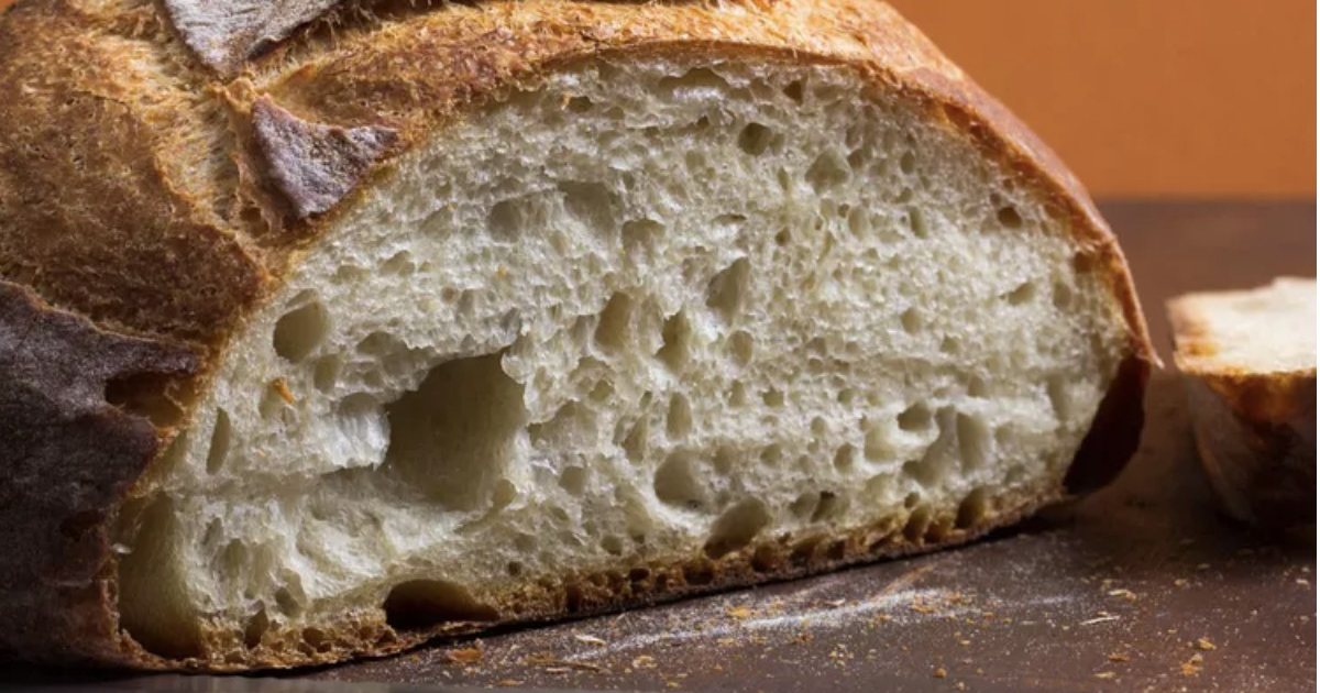 A cut loaf of crusty bread